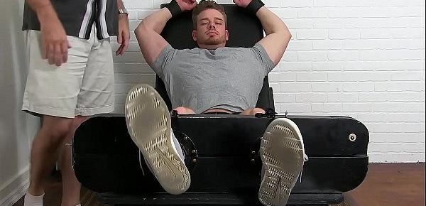  Restrained bodybuilder Ryan Sparks endures a fierce tickling